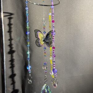Multicolored butterfly centerpiece, with pink, blue, & yellow strands & teardrop prism