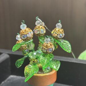 Gold “flowers” with gems in green 1" pot