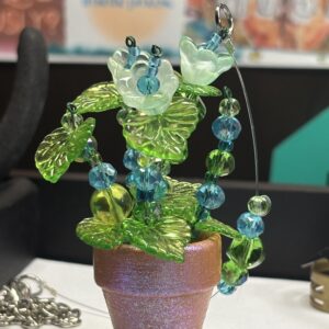 Green & blue flowers in sparkly 1" pot
