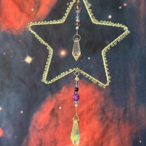 Star shaped frame wrapped in light blue beads with clear prisms